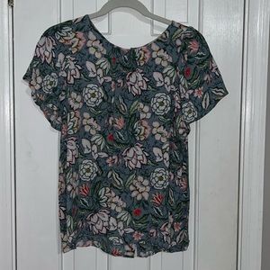 Loft brand blue floral shirt with button detail on back.